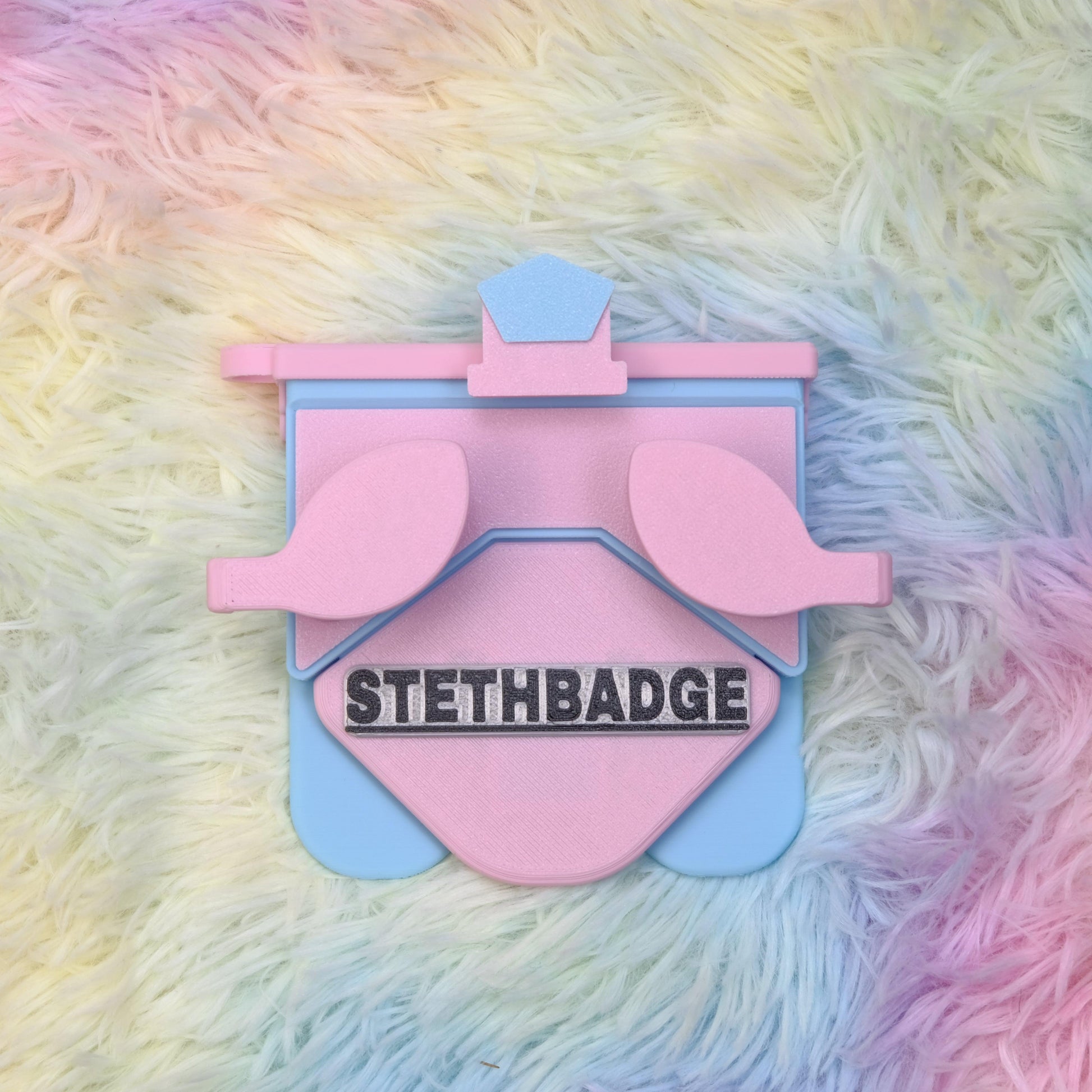 A Chalk-Pink-Sky-Blue-colored Stethoscope Holder or Nurse tool or Nurse accessory for nurses called Stethbadge.
