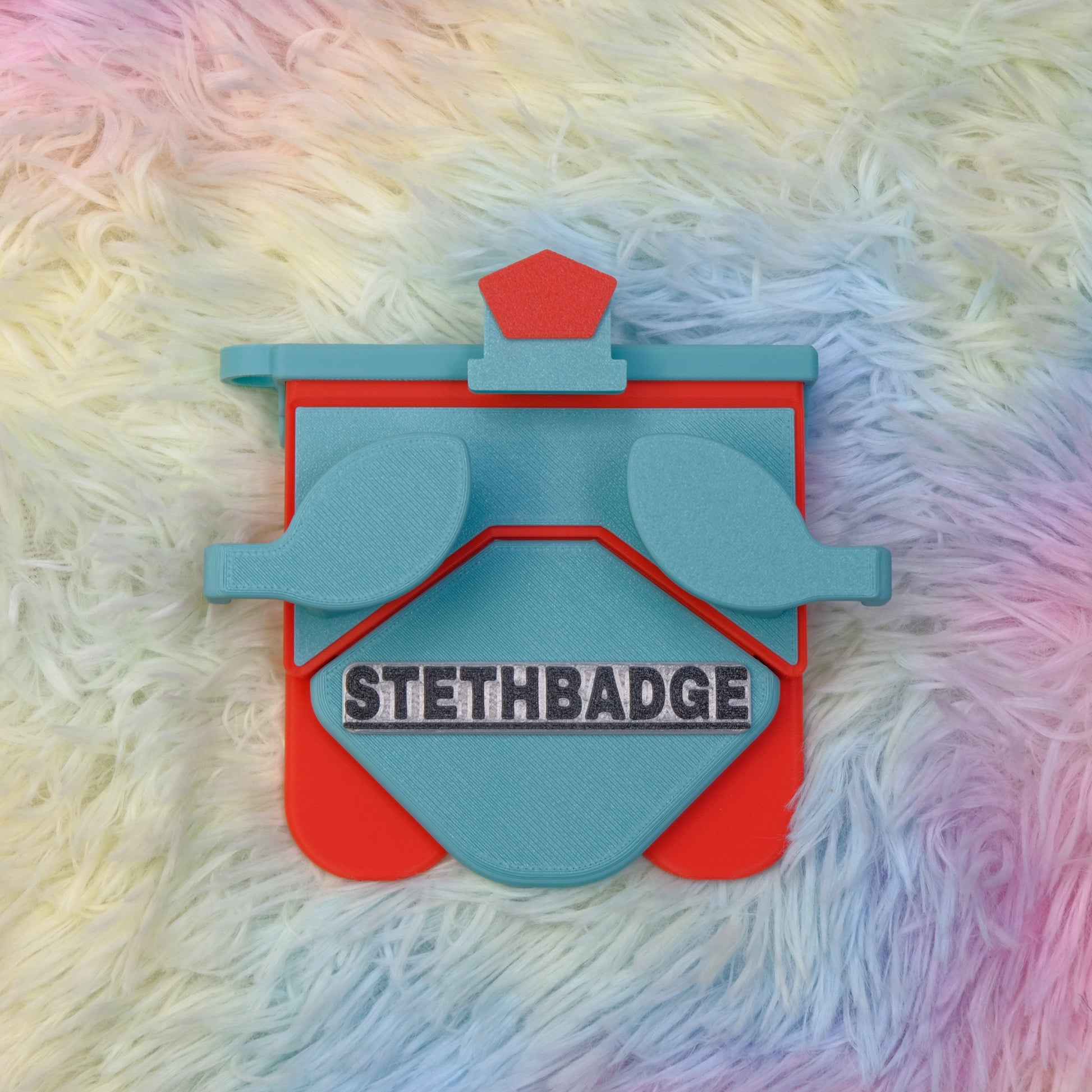 Teal Green and Pop Red-colored Stethoscope Holder or Nurse tool or Nurse accessory for nurses called Stethbadge.